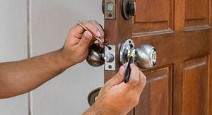 Lock smith changing a door knob